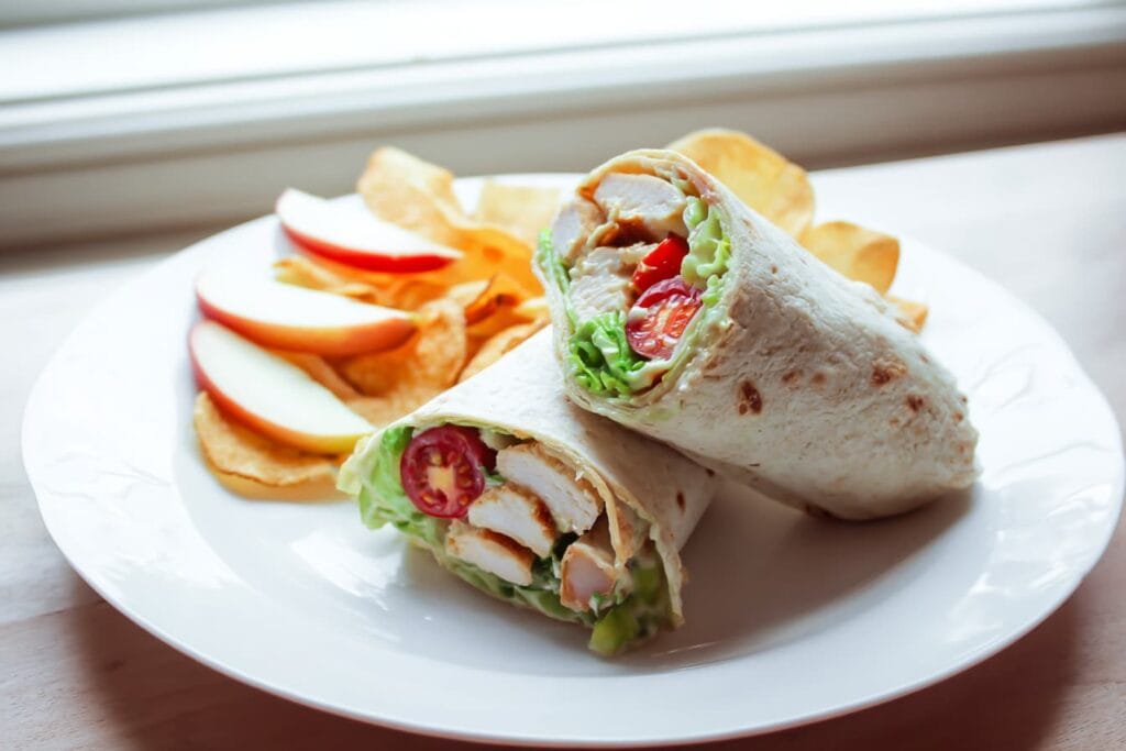 Chicken Caesar Salad Wrap (The Best Easy Lunch You’ll Crave Again) 6 Chicken Caesar wrap served with veggie chips and fruit
