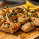 What is the Best Way to Cook Diced Chicken? 5 Juicy diced chicken pieces on a cutting board with lemon and parsley 150x150 1