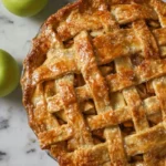 Freshly baked classic apple pie with golden crust and sliced apples