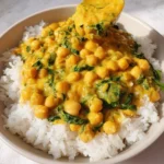 Creamiest Coconut Chickpeas served over rice in a bowl