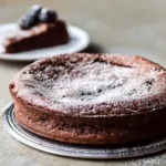 Delicious slice of Flourless Chocolate Cake with rich chocolate frosting