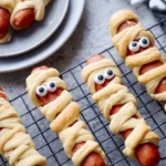 Halloween Mummy Hot Dogs wrapped in pastry, perfect for a spooky treat.
