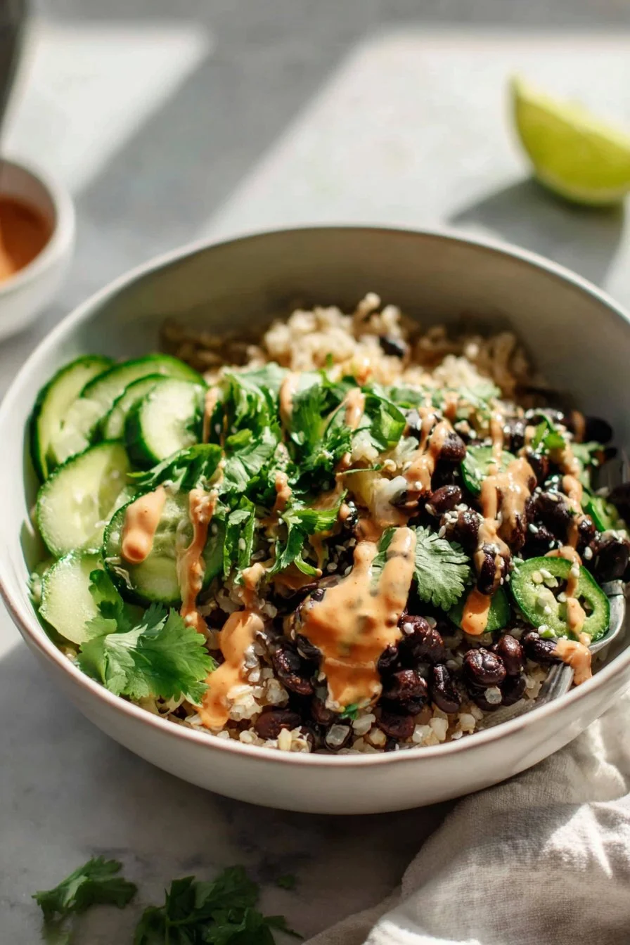 Black Bean Nourish Bowl with Creamy Ginger Sriracha Dressing 1 Black Bean Nourish Bowl with Creamy Ginger Sriracha Dressing served in a bowl