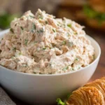 A bowl of classic tuna salad with fresh ingredients and herbs