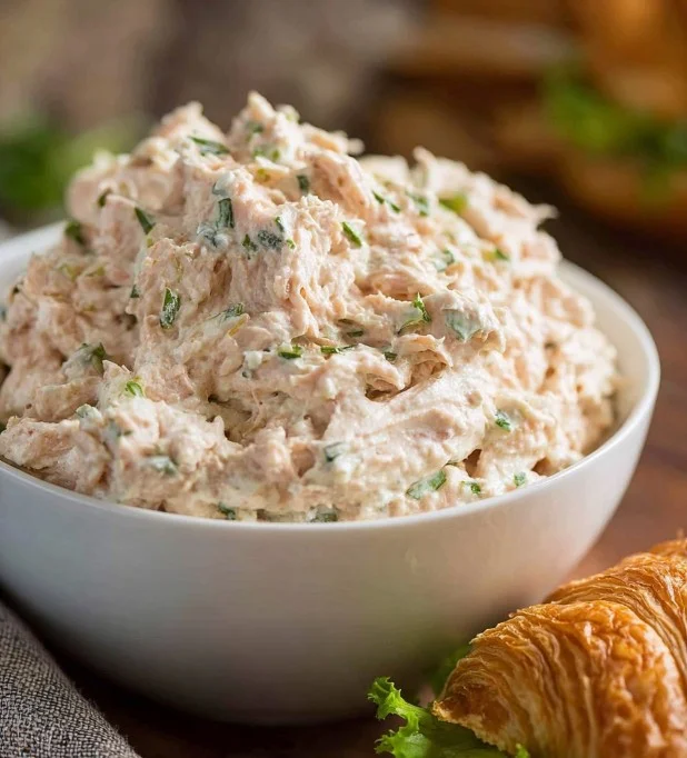 A bowl of classic tuna salad with fresh ingredients and herbs