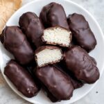 Stacked 3-Ingredient Healthy Mounds Bars with dark chocolate shells and coconut centers