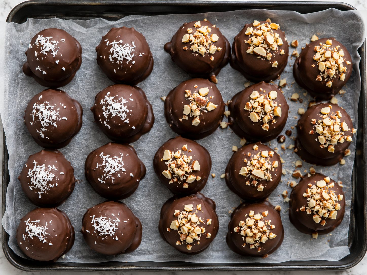 3-Ingredient Mounds Bites: No-Bake Coconut Candy You Roll and Dip 4 Chocolate-dipped 3-Ingredient Mounds Bites arranged on waxed paper