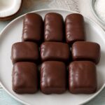 Coconut chocolate candy bars unmolded and arranged on a plate